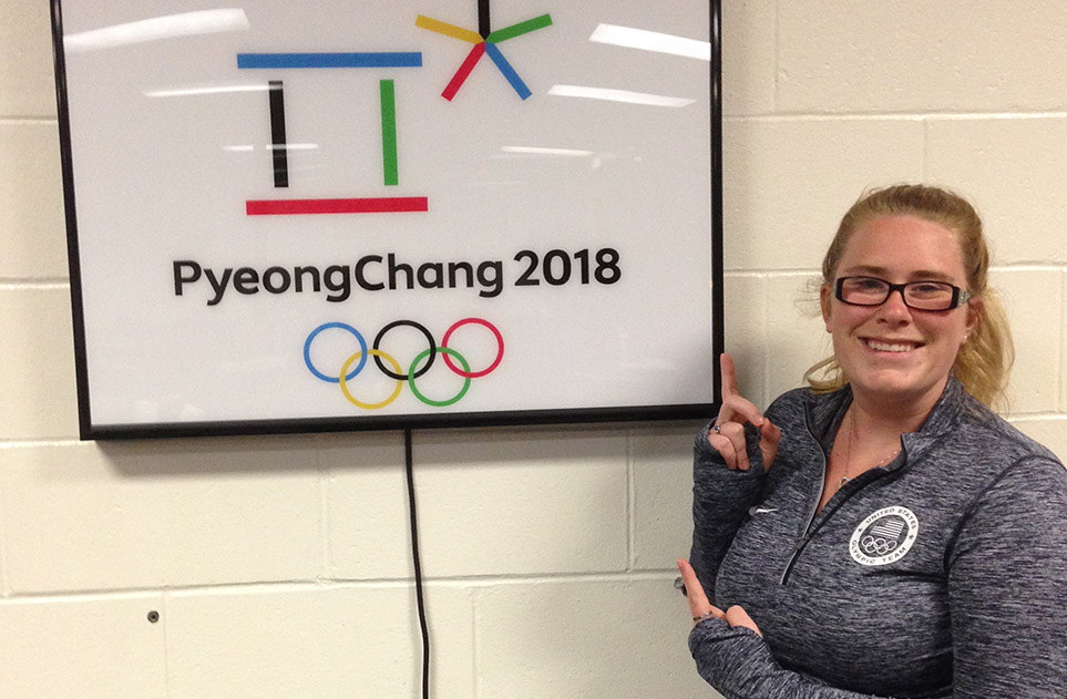 During her internship at the Olympic Training Center in Lake Placid, New York, Lauren Rittle points to a sign counting down to the 2018 Olympics in PyeongChang, South Korea.